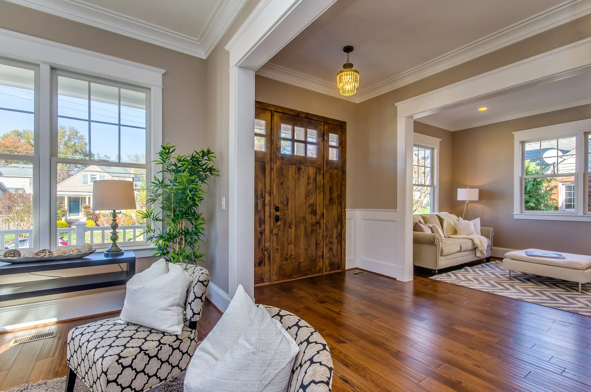 Entry foyer with hardwood floors and a solid wood front door