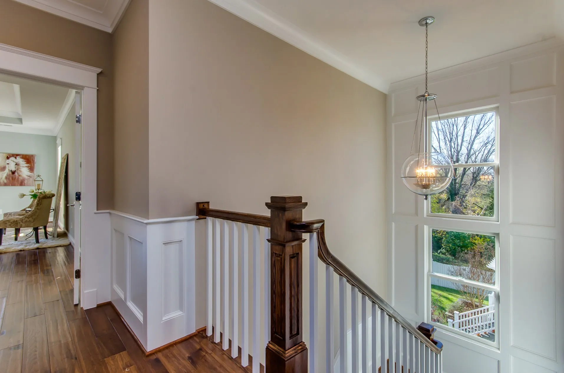 Custom handrails and wall paneling in a finished stairwell